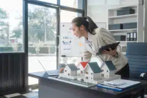 Property management tips in Phuket: Real estate agent analyzing property models.