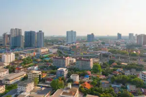 Freehold Property in Thailand: Aerial view of Bangkok city skyline with modern buildings.