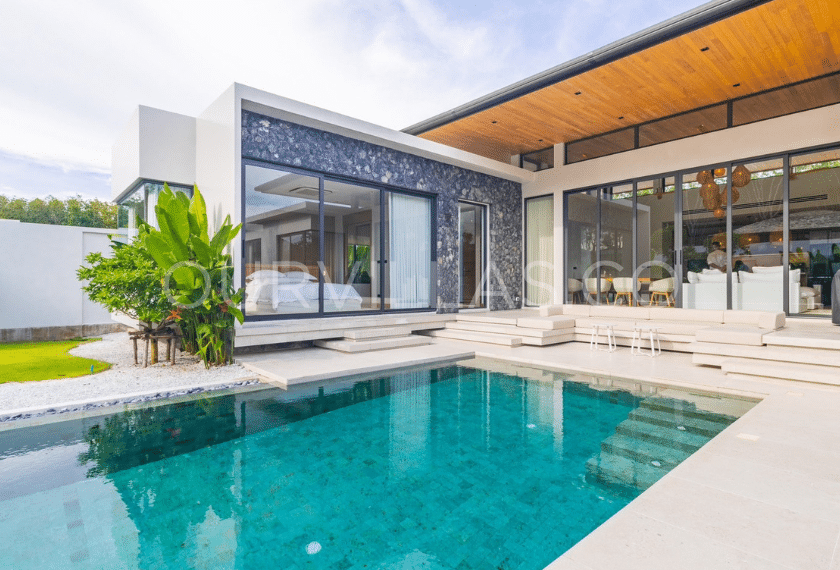 Modern villa with a private pool and lush greenery.