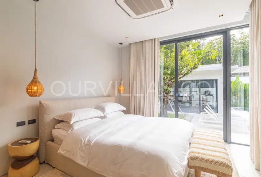 Cozy master bedroom with a garden view.