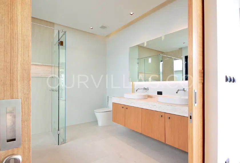 Spacious modern bathroom with dual sinks.