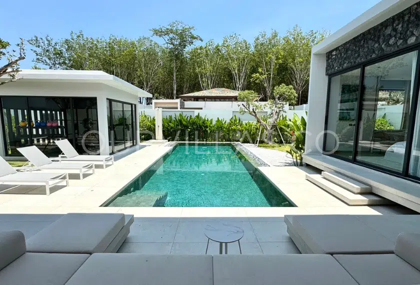 Modern Pool Villa in Phuket: Luxurious private pool with lounge chairs.