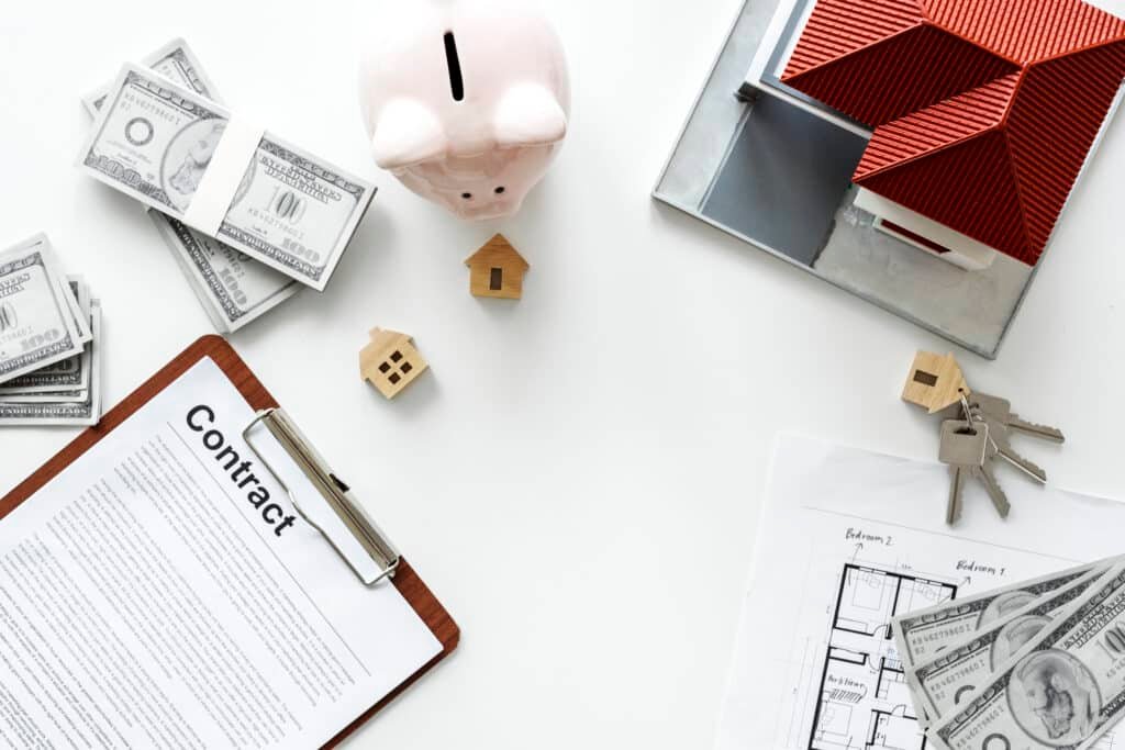 Property management in Phuket: Real estate contract with money, keys, and house model.