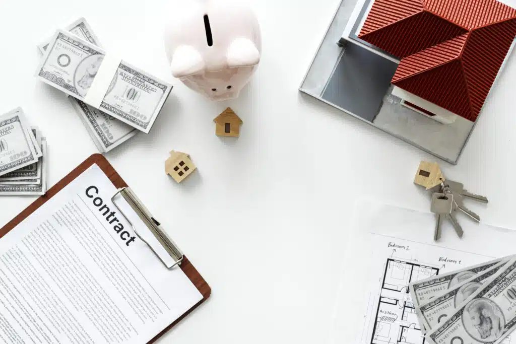 Property management in Phuket: Real estate contract with money, keys, and house model.