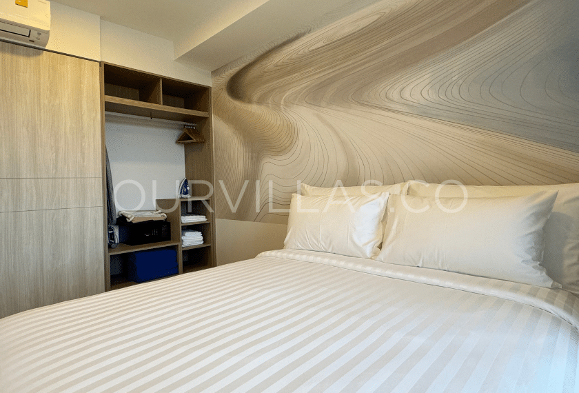 Luxury condo in Laguna Phuket: Cozy condo bedroom with a modern accent wall.