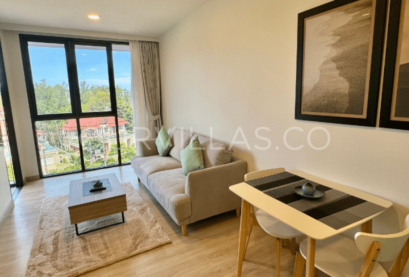 Stylish condo living room with a scenic balcony view.