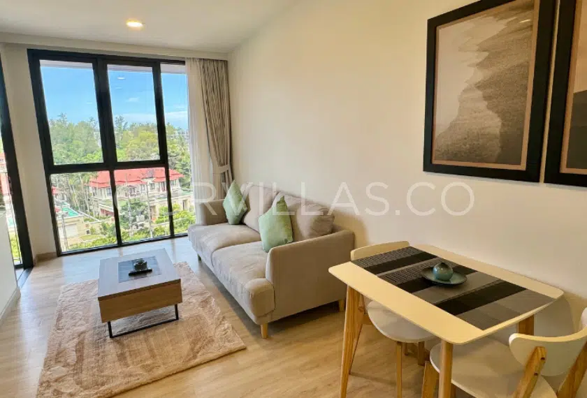 Stylish condo living room with a scenic balcony view.