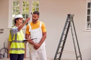 House Maintenance Checklist: Surveyor and decorator discussing renovation plans.
