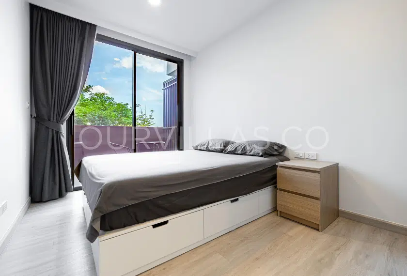 Cozy bedroom with balcony and trees