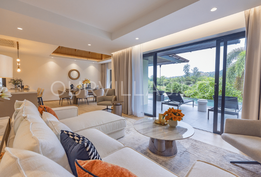 Living room with balcony and lush green views