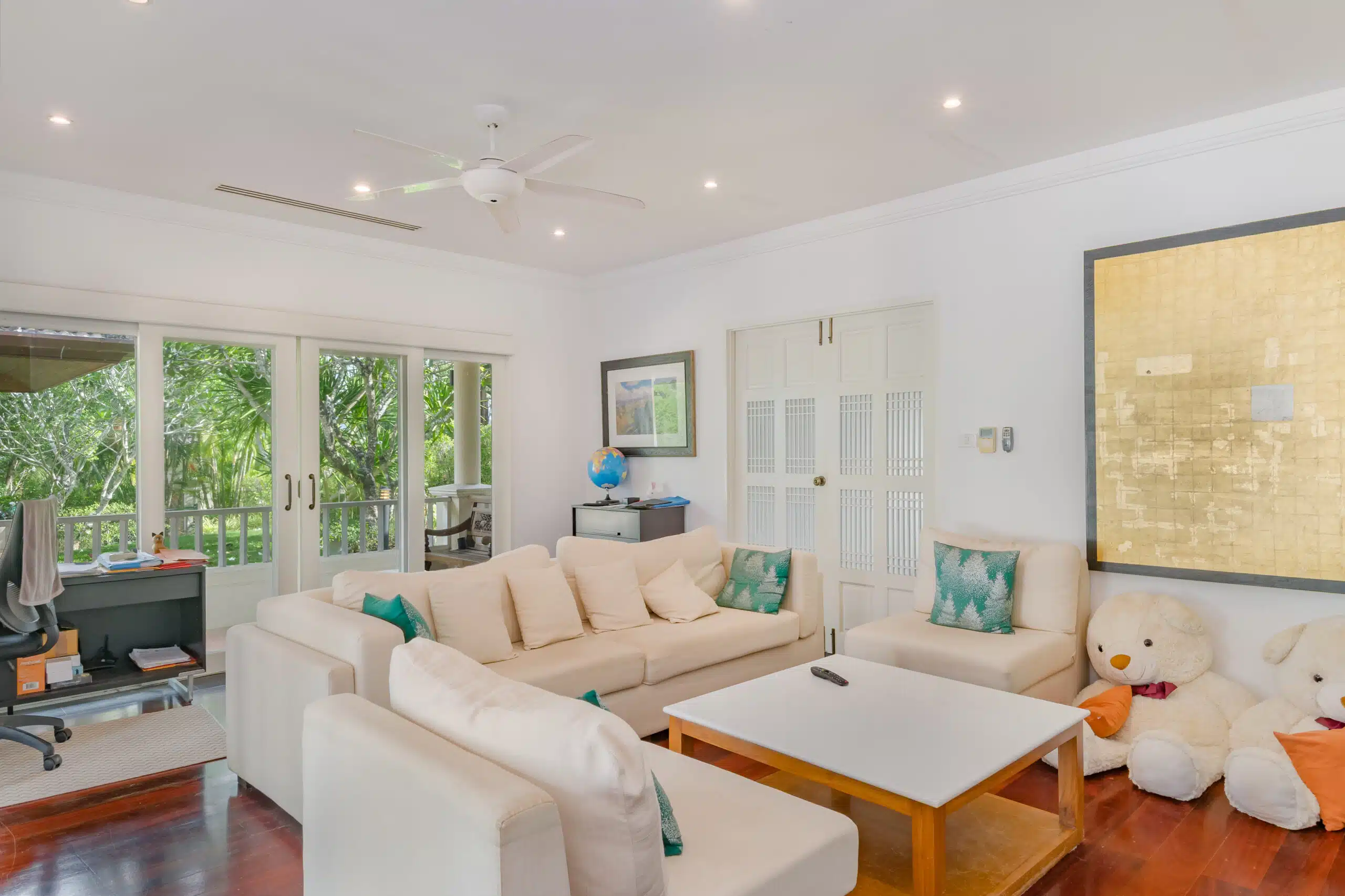 Family lounge with cream sofas and garden access