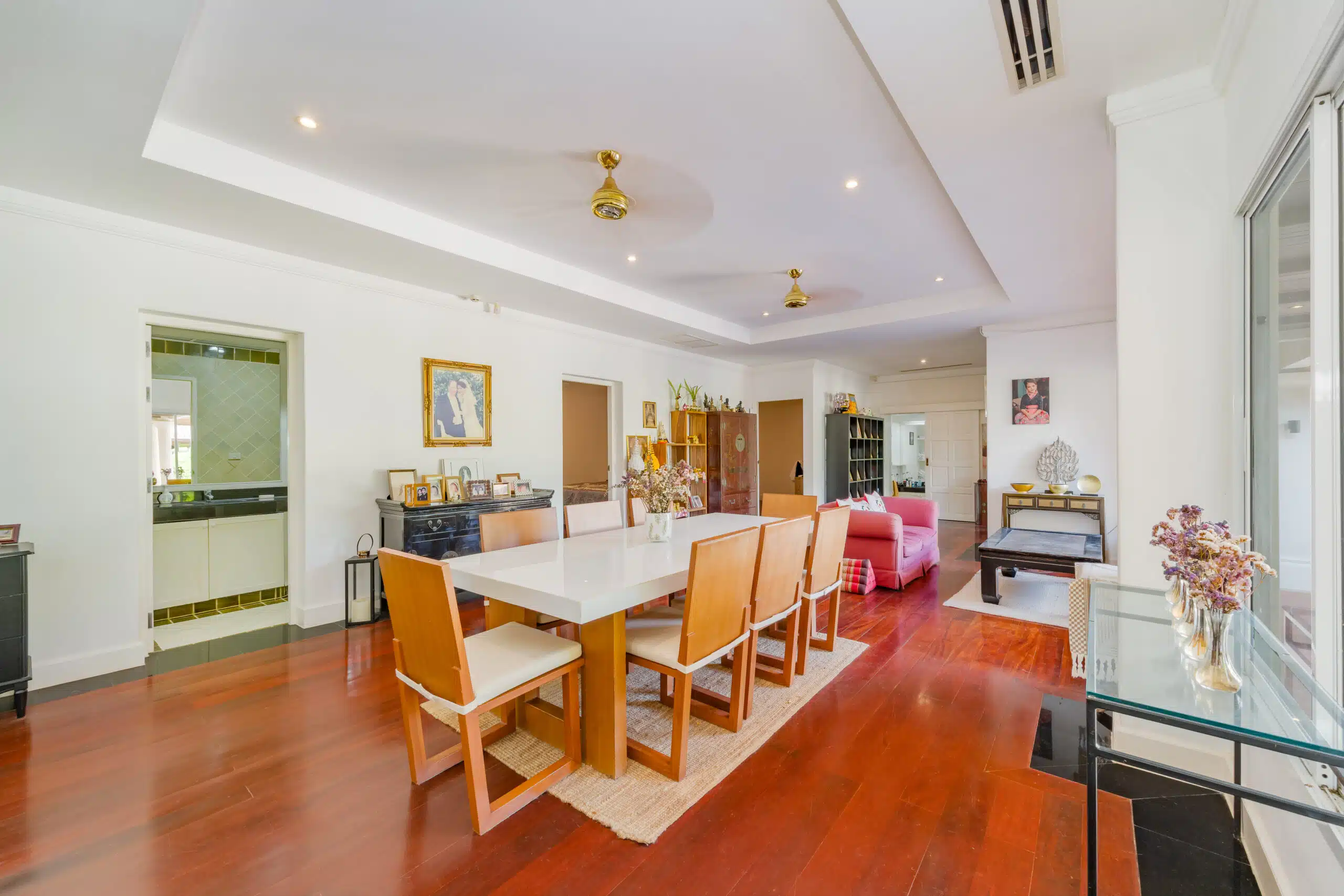Long dining room with large table and hardwood floor