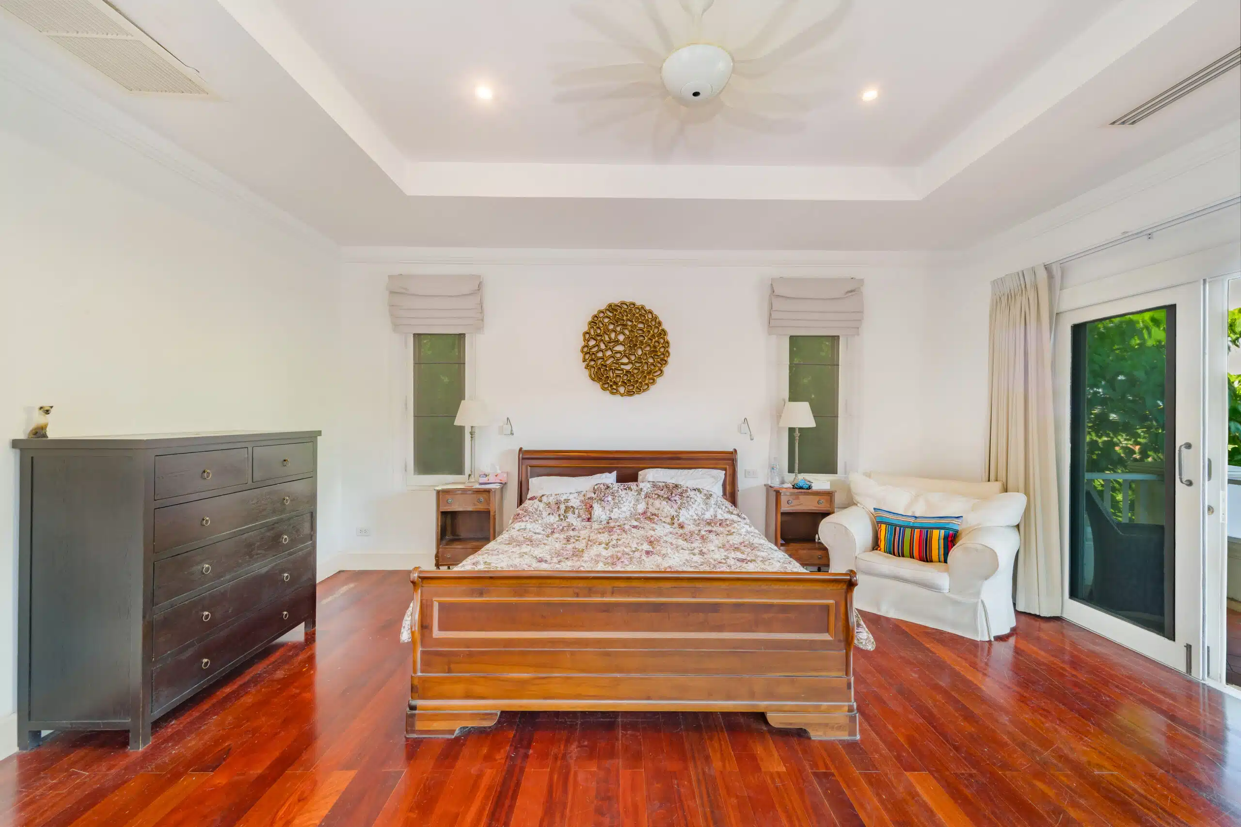 Master suite with balcony and dark wood flooring