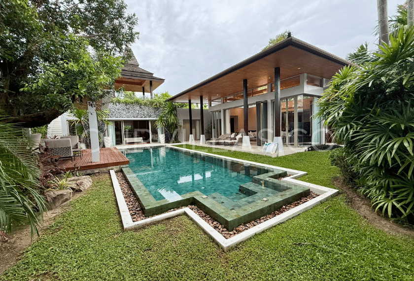 Villa exterior with tropical greenery and pool view