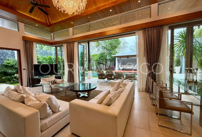 Elegant living area with chandelier and pool view