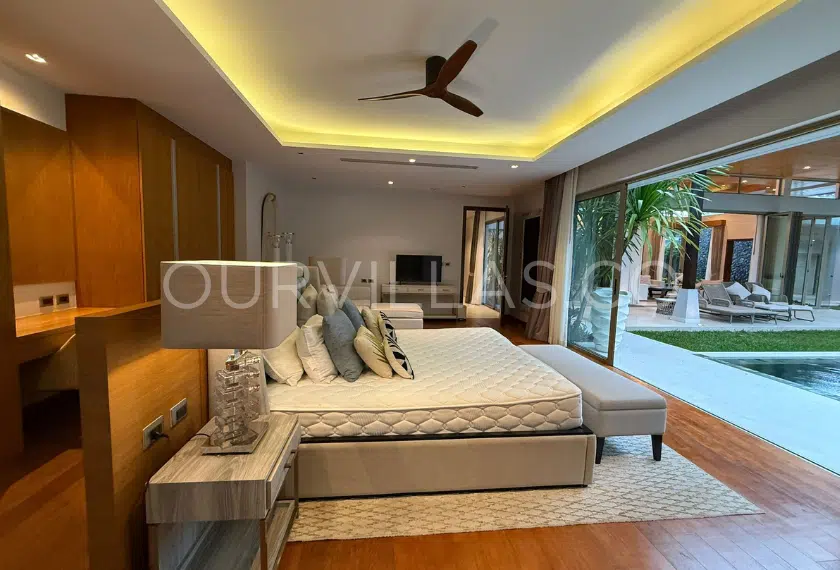 Spacious master bedroom with pool access view