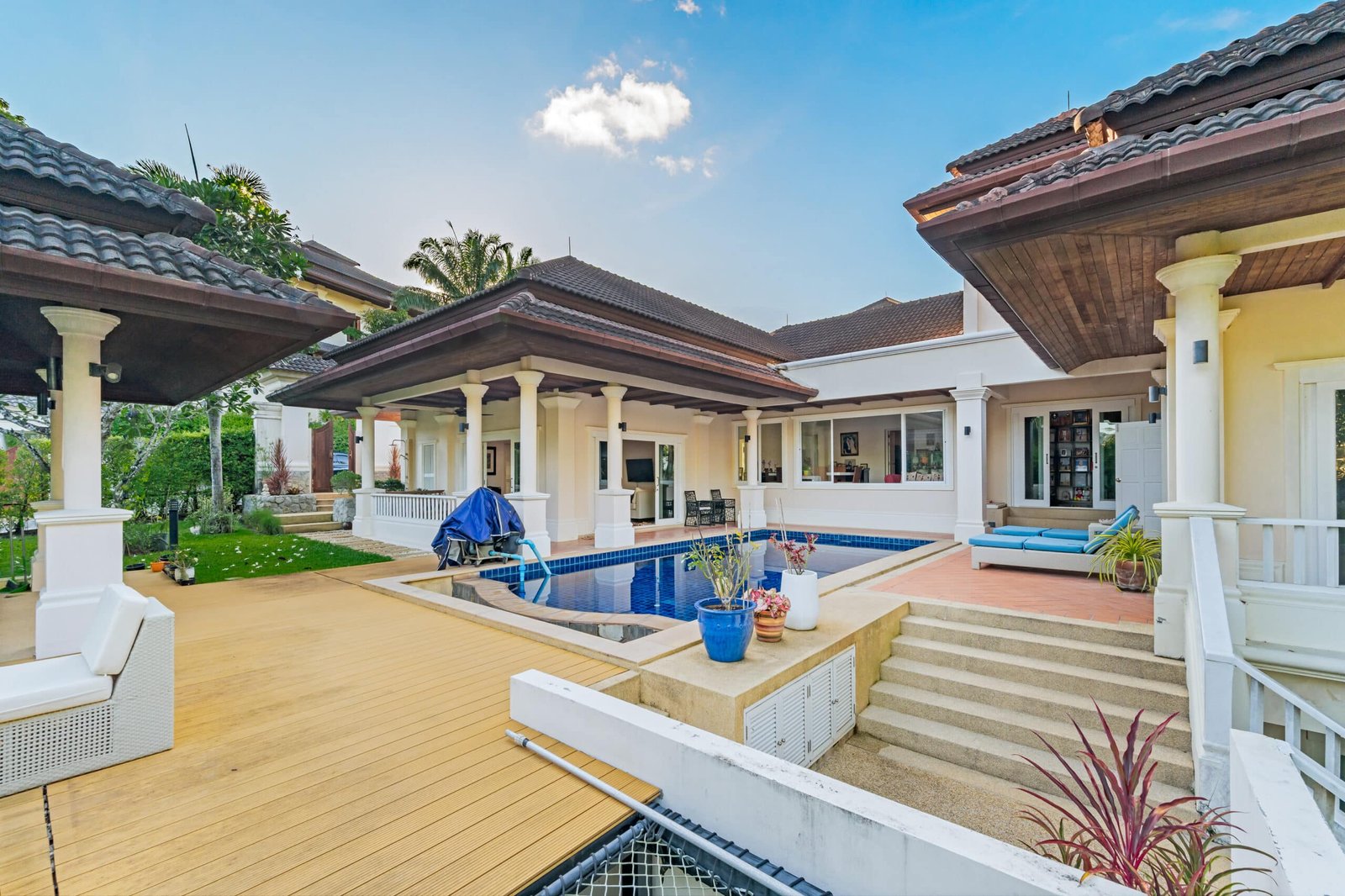 Pool villa exterior with shaded patio and seating