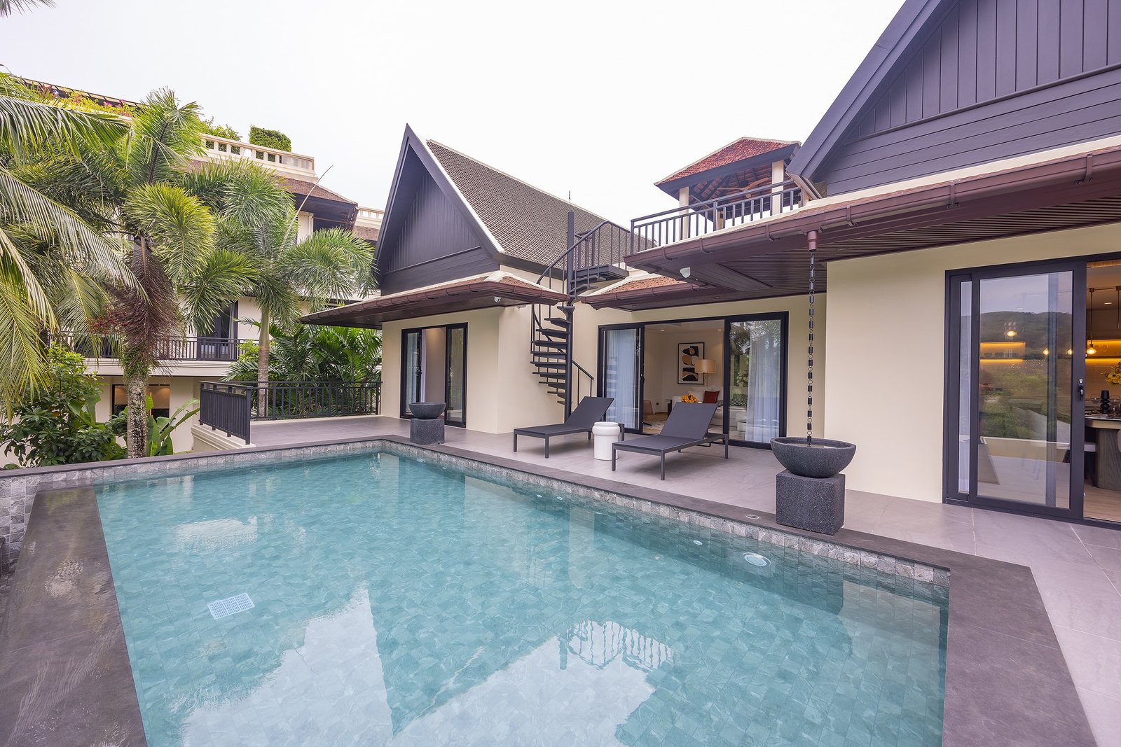 Private villa terrace with pool and spiral staircase
