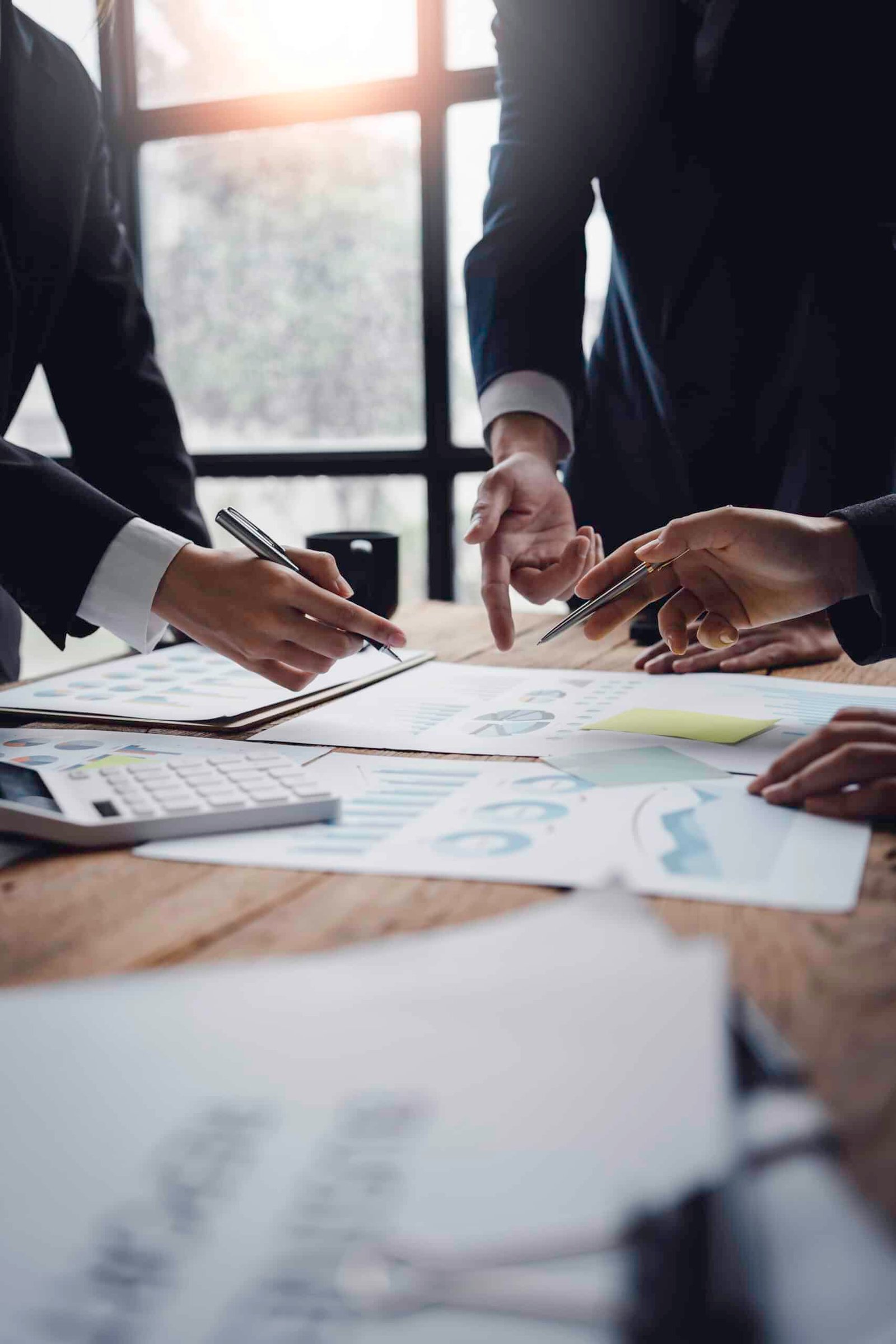 Property management professionals reviewing reports and performance charts, representing consistent property management services and operational excellence in Phuket.