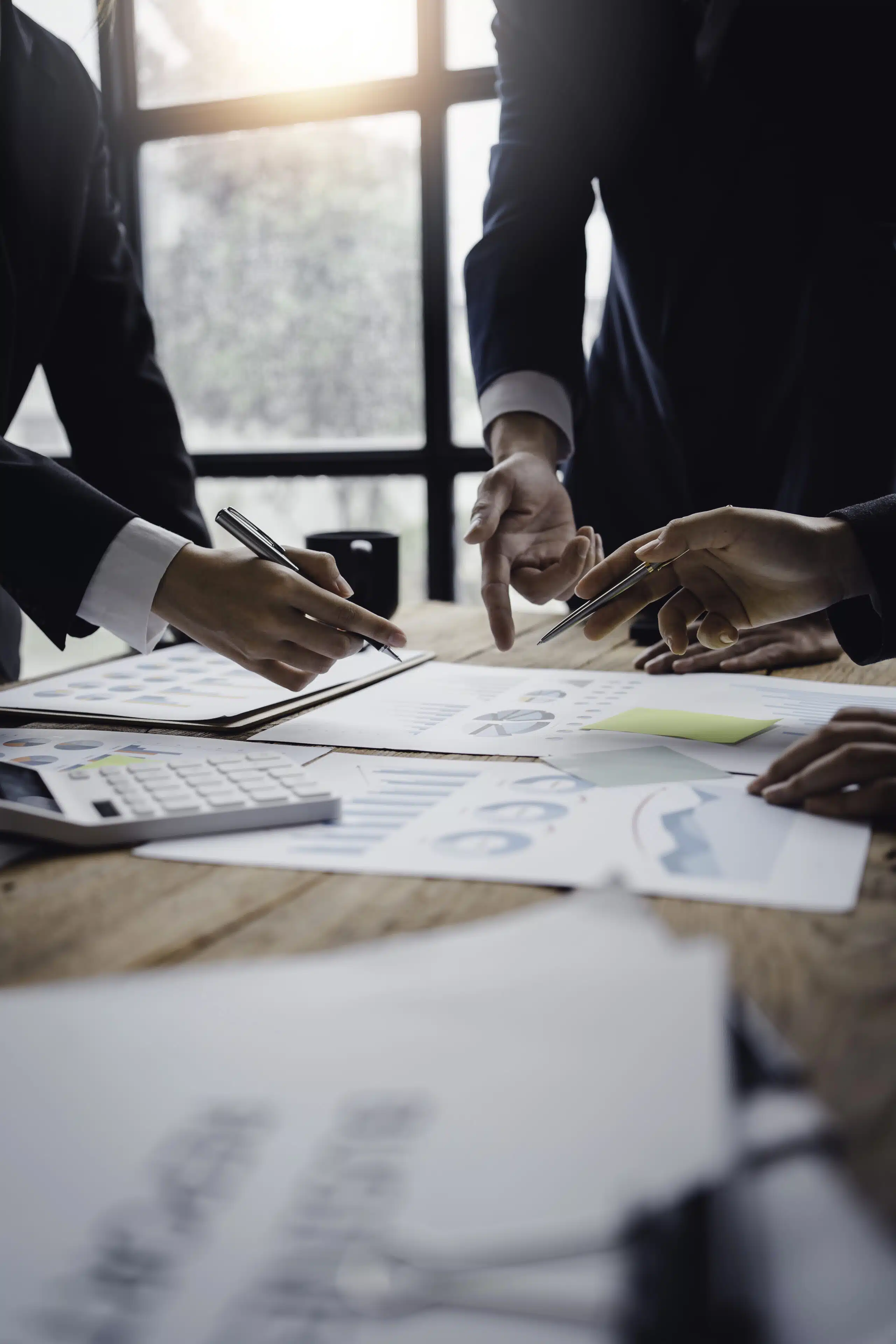 Property management professionals reviewing reports and performance charts, representing consistent property management services and operational excellence in Phuket.